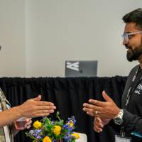 Two event guests in conversation with each other